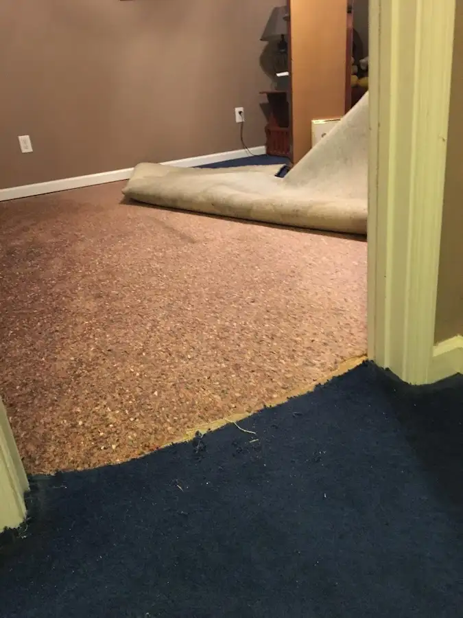 Carpet pad removal revealing water damage during Water Mitigation Services in Pittstown